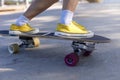 Close-up Asian women surf skate or skateboard outdoors on beautiful morning. Happy young women play surf skate at ramp park on