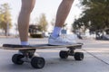 Close-up Asian women surf skate or skateboard outdoors on beautiful morning. Happy young women play surf skate at ramp park on