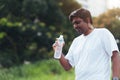 Sport runner black man wear athlete headphones he drinking water from a bottle Royalty Free Stock Photo