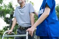 Close up of Asian young woman nurse visit and take care disabled senior elderly man. Caregiver doctor serve physical therapy for o Royalty Free Stock Photo