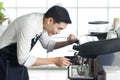 Close up of Asien barista man preparing coffee for customer in coffee shop