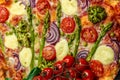 Close up asparagus tart. pie filled with fresh asparagus, sweet peas, mozzarella and cherry tomatoes. Vegan food recipe background Royalty Free Stock Photo