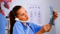 Close up of assistant answering phone checking patient x-ray Royalty Free Stock Photo