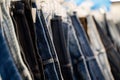 Close up of assorted denim jeans hanging on clothing rack Royalty Free Stock Photo