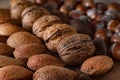 Close up of assortment nuts on a wooden table: wallnuts, almonds Royalty Free Stock Photo
