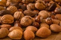 Close up of assortment nuts on a wooden table: wallnuts, almonds Royalty Free Stock Photo