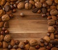 Close up of assortment nuts on a wooden table: wallnuts, almonds