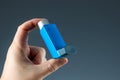 Close-up with an asthma inhaler in a male hand, asthmatic attack. The concept of treatment of bronchial asthma, cough, allergies, Royalty Free Stock Photo