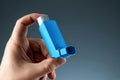 Close-up with an asthma inhaler in a male hand, asthmatic attack. The concept of treatment of bronchial asthma, cough, allergies, Royalty Free Stock Photo