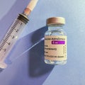 London, UK - 08 Mar 2021: Close-up of Astra Zeneca Pharmaceutical`s coronavirus vaccine next to a syringe