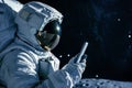 Close up of an astronaut looking at the smartphone on lunar spacewalk Royalty Free Stock Photo