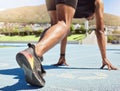 Close up of an athlete getting ready to run track and field with his feet on starting blocks ready to start sprinting Royalty Free Stock Photo