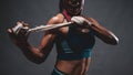 Close up of athletic healthy lean tone top body of asian woman holding white strap with both hands preparing for training or