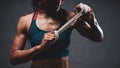 Close up of athletic healthy lean tone top body of asian woman holding white strap with both hands preparing for training or
