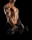 Close-up of athletic man pumping up muscles with dumbbell