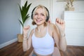 Close up of athletic young woman, cute female model in wireless headphones, dancing to favorite song, listens to music Royalty Free Stock Photo