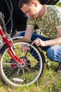 Close up of attractive adult man, Handsome Bike Mechanic pumping up bicycle wheel World Bicycle Day Royalty Free Stock Photo