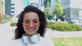 Close up of attractive cheerful pretty brunette woman standing outside in town looking at camera and smiling. Joyful Royalty Free Stock Photo