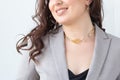 Close up attractive female model gold necklace and earrings. Woman wearing jewellery. Jewellery photo for e commerce and