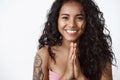 Close-up attractive grateful charming african-american curly-haired girl with tattoos, hold hands in pray smiling toothy