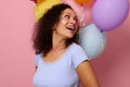 Close-up of attractive happy cheerful mixed race woman smiling with a beautiful toothy smile looking through her shoulder at Royalty Free Stock Photo