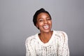 Close up attractive laughing black woman in white sweater