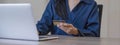 Close up attractive millennia Asian female holding her smartphone and credit card, using mobile banking app or online