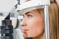 close up of attractive patient examining her eyes with slit lamp