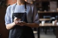 Close up attractive waitress ready to take order in coffeehouse