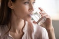 Close up attractive woman drinking pure fresh mineral water