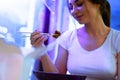 Close up of attractive woman eating asian food with chopsticks at restaurant. Royalty Free Stock Photo