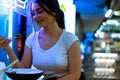 Close up of attractive woman eating asian food with chopsticks at restaurant. Royalty Free Stock Photo