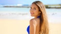 Close up of attractive woman standing at beach and looking at ca Royalty Free Stock Photo