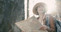 Close up Attractive young woman in stylish hat and a tourist map in her hands looking around Royalty Free Stock Photo