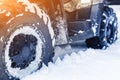 Close-up ATV 4wd quad bike in forest at winter. 4wd all-terreain vehicle stand in heavy snow with deep wheel track. Seasonal Royalty Free Stock Photo