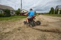 Close-up of ATV wheels kicking up dust and sand on a sharp turn. A child rushes through the sand on an ATV, kicking up Royalty Free Stock Photo