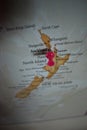 Close up of Auckland pin pointed on the world map with a pink pushpin Royalty Free Stock Photo