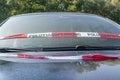 Close up of an Audi A3 after an accident with police barrier tape with German word for police barricade, Germany