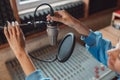 Close-up of audio engineer working in sound record studio, using microphone, mixing board, software to create new song Royalty Free Stock Photo