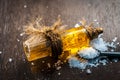 Close up of aurvedic herb camphor powder in a small spoon and its oil on brown wooden surface in dark Gothic colors is helps in