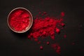 Close-up of auspicious red orange colored Sindoor or kumkum in brass small bowl during any Hindu pooja over black Royalty Free Stock Photo