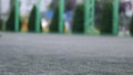 Close up aut focus of men`s feet playing and running through football field in the city park. Shallow depth of the field