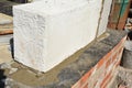 Close up on autoclaved aerated concrete block laying on foundation waterproofing membrane