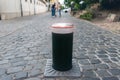 Close-up automatic metal rising smart security bollard barrier for safety car traffic in old city center pedestrian area