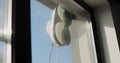 Close up automatic window cleaning robot operating on residential window. Simplicity and convenience of window cleaning. Royalty Free Stock Photo
