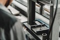 Close up of automechanic changing the silent block in the hydraulic press in the car service