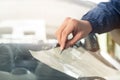 Close up Automobile glazier worker fixing and repair windscreen or windshield of a car in auto service station garage Royalty Free Stock Photo