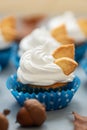 Close up autumn cupcakes decorated with cream and cookies leaves on gray wooden background. Soft focus. Thanksgiving day or Royalty Free Stock Photo