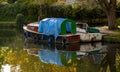 Close up autumn image of two river boats tied to the side of river Yeo in Norwich Royalty Free Stock Photo