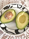 Avocado halves on a plate Royalty Free Stock Photo